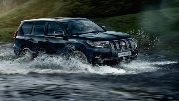 Toyota Land cruiser TX passing through water.